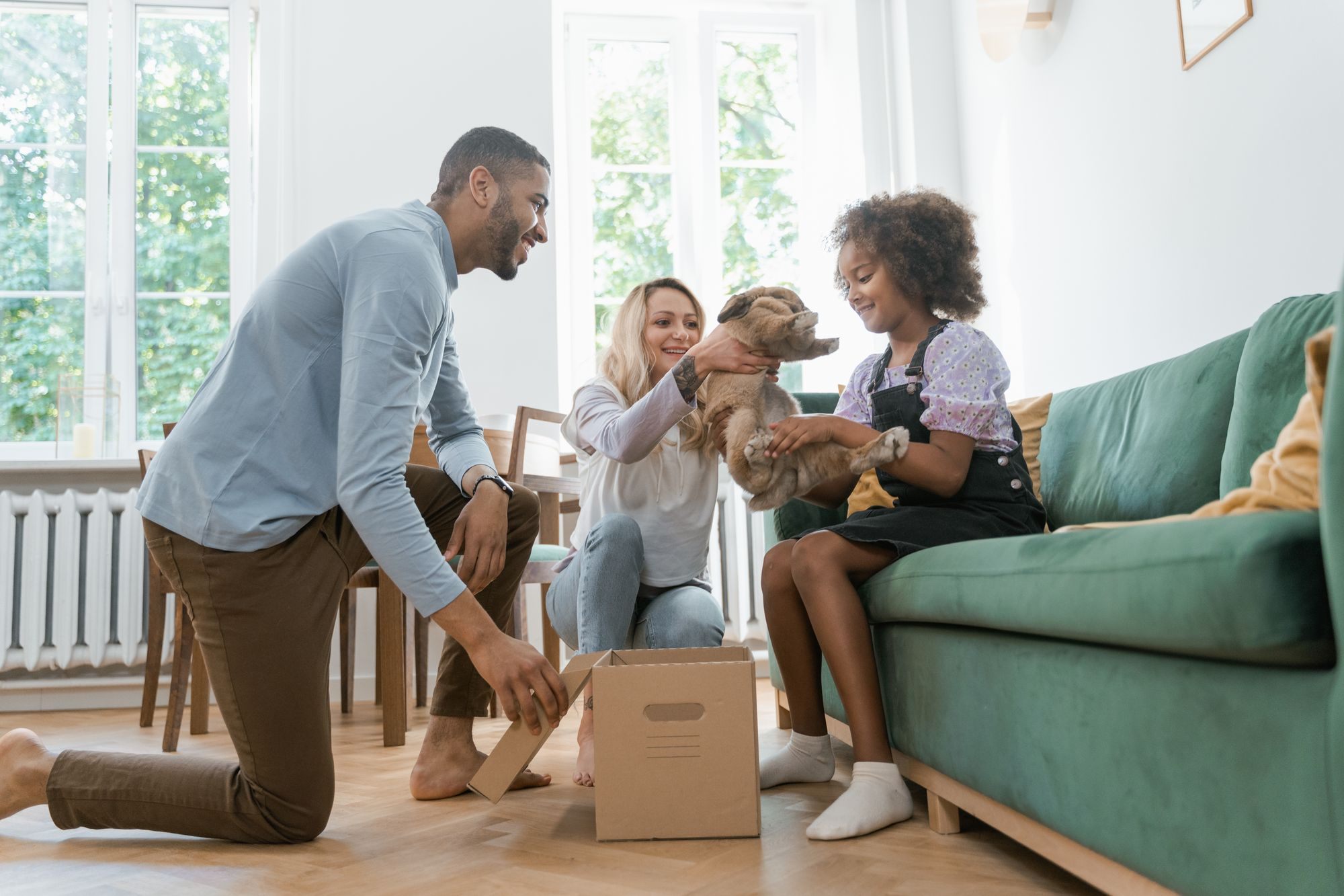 Family unpacking boxes in their new living room
