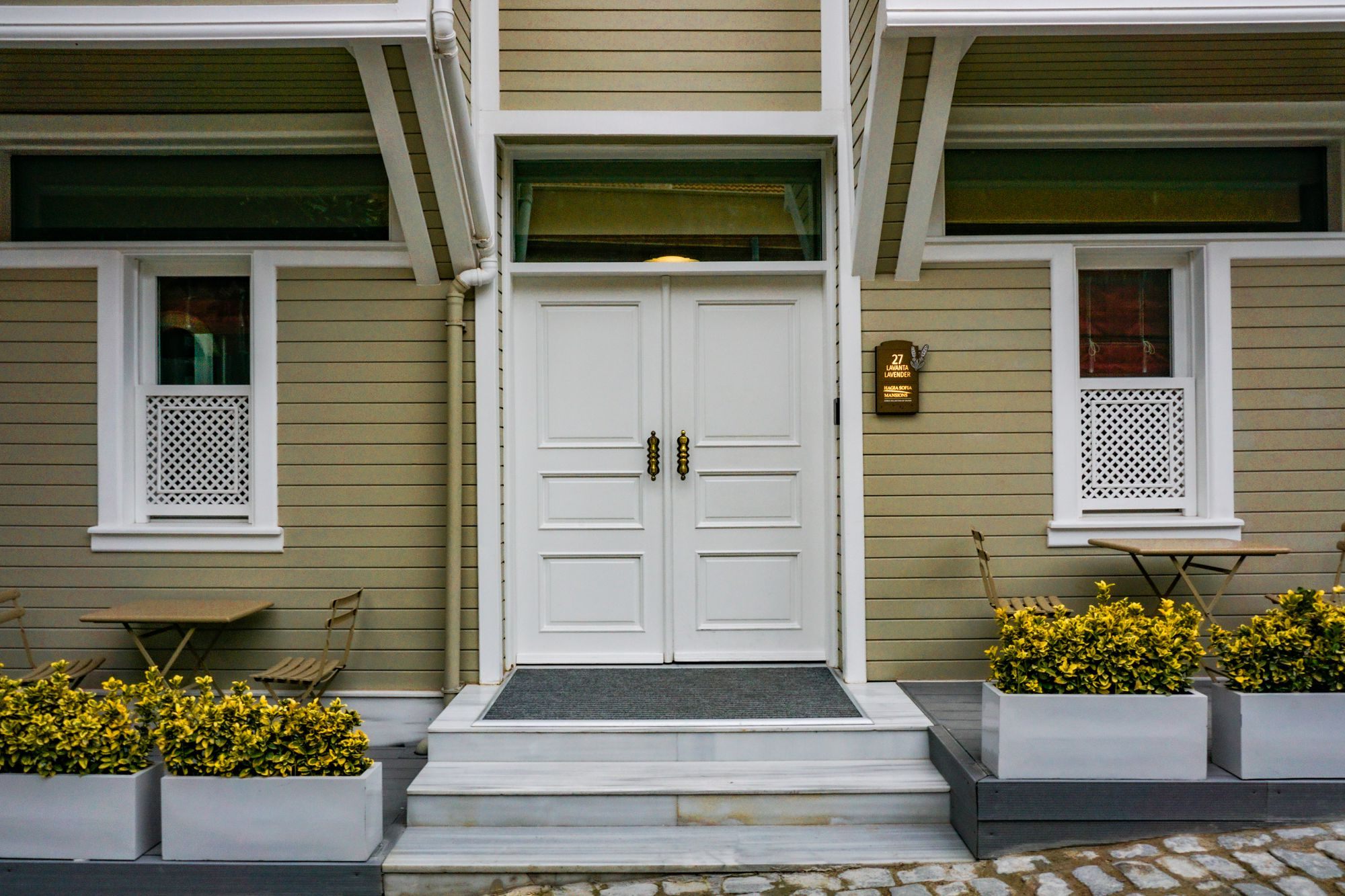 Front door of a house with a white porch